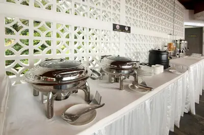 a buffet line with pots and pans and dishes at Le Villagio Resort & Domes in Sultan Bathery
