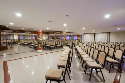 a room with rows of chairs in a hall at Sree Gokulam Sabari in Guruvāyūr