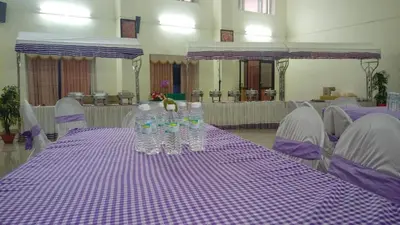 a purple table with water bottles on top of it at Sree Gokulam Sabari in Guruvāyūr
