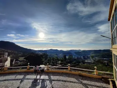 a group of people standing on a balcony looking at the view at Tulips Valley View Resorts in Ooty