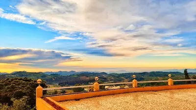 a view of the mountains from a balcony at Tulips Valley View Resorts in Ooty