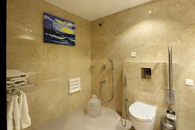 a bathroom with a shower and a toilet in it at Park Residency Koyilandi in Quilāndi