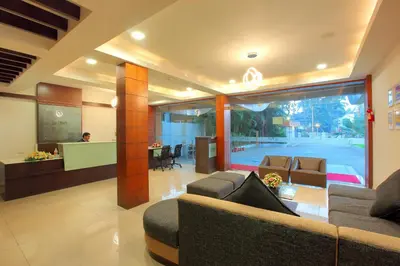 a living room with two couches and a reception desk at Park Residency Koyilandi in Quilāndi