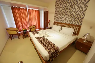 a bedroom with a large bed in a room at Park regency in Angamali