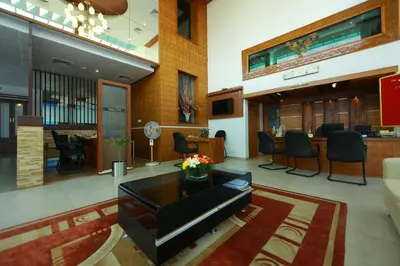 a lobby with a waiting area with chairs and a table at Park regency in Angamali