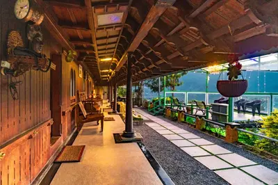 a porch of a building with a view of the ocean at Castillo De Woods , The Private Luxury Villa , 8 BHK, Vattavada in Kottakamboor