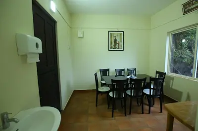 a dining room with a table and chairs and a window at Castillo De Woods , The Private Luxury Villa , 8 BHK, Vattavada in Kottakamboor
