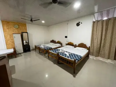a room with two beds in a room with at Greenwoods Nature Camp in Mudumalai National Park