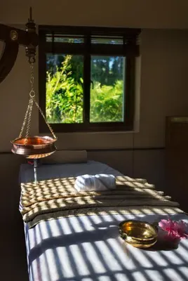 a bedroom with a bed with a window and a bowl on it at Purple Palms Resort & Spa in Kushālnagar