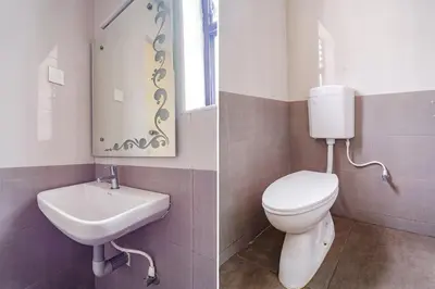 a bathroom with a toilet and a sink at FabHotel ESS Paradise in Coimbatore