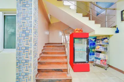 a staircase with a red vending machine in a building at Super Hotel O Airport Road Coimbatore in Coimbatore