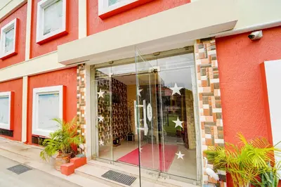 a red brick building with a glass storefront at Super Hotel O Airport Road Coimbatore in Coimbatore