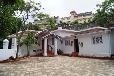 a white house with a driveway in front of it at Fairy Glen in Coonoor