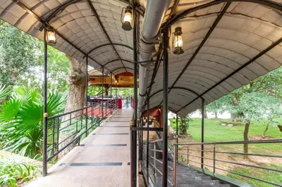 a train station with a platform and a train at KSTDC Hotel Mayura Riverview Srirangapatna in Seringapatam