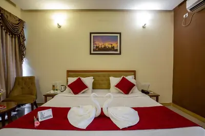 a hotel room with a bed with two wedding towels at KSTDC Hotel Mayura Hoysala, Mysore in Mysore