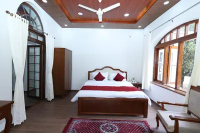 a bedroom with a large bed with a wooden ceiling at KSTDC Hotel Mayura Sudarshan ,Ooty in Ooty