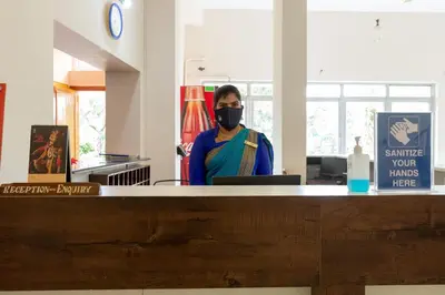 a man wearing a mask in an office at KSTDC Hotel Mayura Kauvery KRS in Hosa Kannambādi