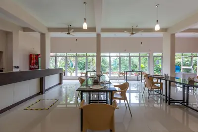 a dining room with a table and chairs at KSTDC Hotel Mayura Kauvery KRS in Hosa Kannambādi