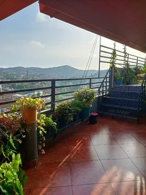 a balcony with potted plants and a railing at Coorg North Breeze Homestay in Madikeri