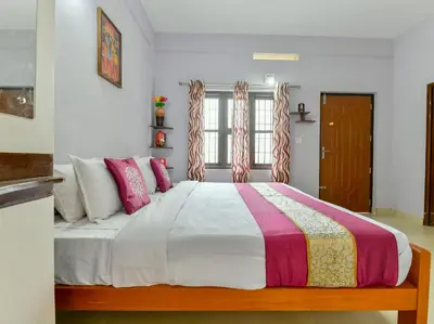 a bedroom with a large bed with pink pillows at Gooseberry Family Retreats - Wayanad by KARAPUZHA RESORTS in Meenangadi