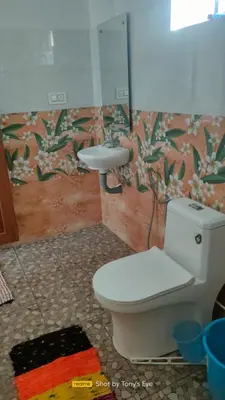a bathroom with a toilet and a sink at Gooseberry Family Retreats - Wayanad by KARAPUZHA RESORTS in Meenangadi