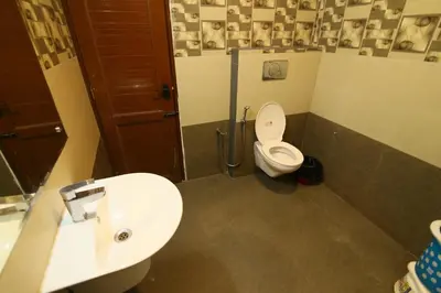 a bathroom with a toilet and a sink at Jays Inn in Munnar