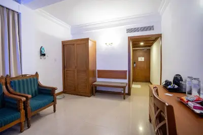 a hospital room with two chairs and a desk at Casino Hotels Ltd in Trichūr