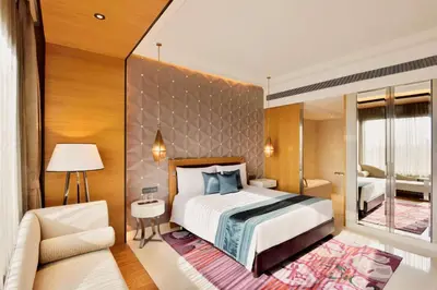 a hotel room with a bed and a chair at Radisson Blu Coimbatore in Coimbatore