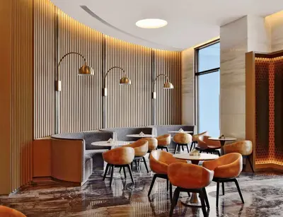 a restaurant with chairs and tables and a bar at Radisson Blu Coimbatore in Coimbatore