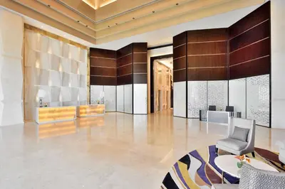 a lobby with a chair and a table at Radisson Blu Coimbatore in Coimbatore