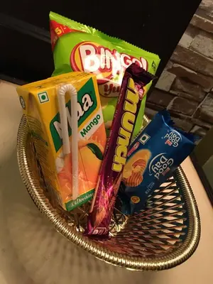 a basket of junk food and snacks on a table at Hotel Palace Tower in Trichūr