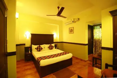 a bedroom with a bed and a ceiling fan at Hotel Palace Tower in Trichūr