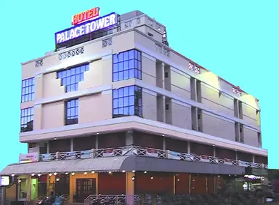 a building with a sign on top of it at Hotel Palace Tower in Trichūr