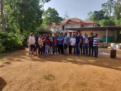 a group of people posing for a picture in front of a house at Vacanza Estate House in Kakkabe