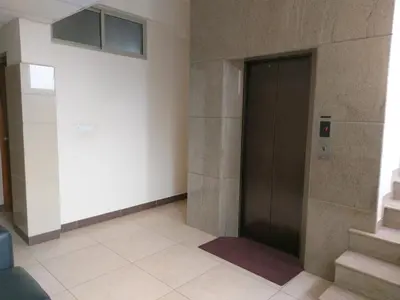a hallway with a door and stairs in a building at Banyan Tree Comforts Mysore in Mysore