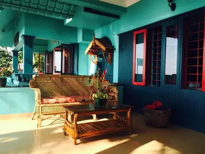 a living room with a couch and a coffee table at Majo House in Cherai Beach