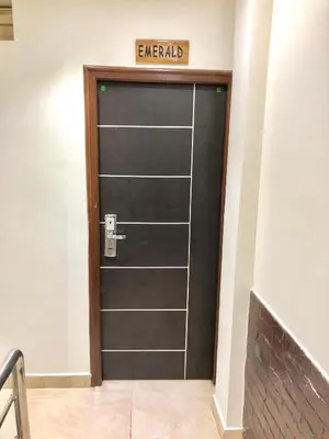 a black door with a sign that reads emerald at Hotel Landmark in Ooty