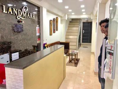 a man standing at a counter in a store at Hotel Landmark in Ooty