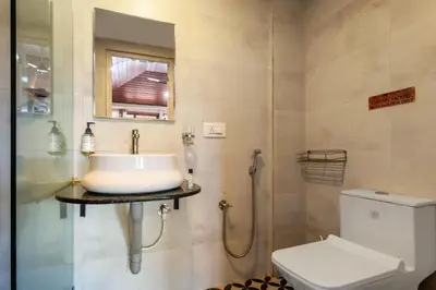 a bathroom with a sink and a toilet at Treebo Vrindavan, 3 Km From Madikeri Fort in Madikeri