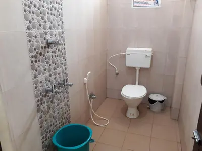 a small bathroom with a toilet and a shower at Pattiah Naidu Palace in Palani