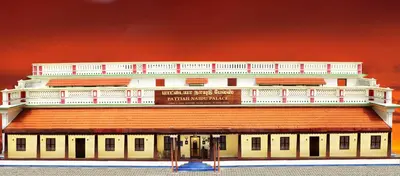 a large white building with a red roof at Pattiah Naidu Palace in Palani