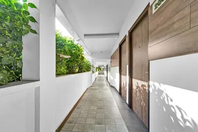 a corridor of a building with plants on the walls at Collection O Kalady Near Airport in Cochin