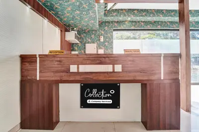 a counter in a restaurant with a sign on it at Collection O Kalady Near Airport in Cochin
