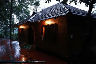 a small building with lights on the side of it at Green Garden Jasmin Cottage in Vayittiri