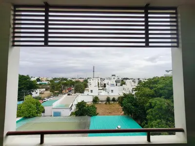 a window with a view of a city at Holiday Residency Coimbatore in Coimbatore