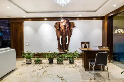 a statue of an elephant on a wall with plants at Hotel Lok Sagar Mysore in Mysore