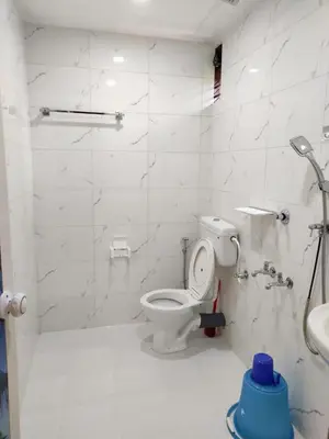 a bathroom with a toilet and a sink at Coconut Garden in Cherai Beach