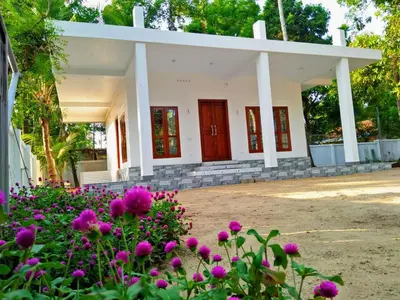 a building with pink flowers in front of it at Coconut Garden in Cherai Beach