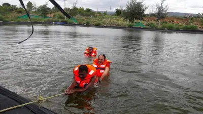 two people in the water in a body of water at Green Peace Bheemeshwari in Halgūr