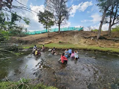 a group of people crossing a river at Wildways Mudumalai Homestay in Masinagudi